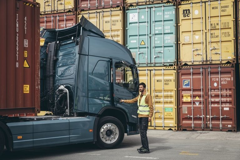 man opening the door of a volvo truck