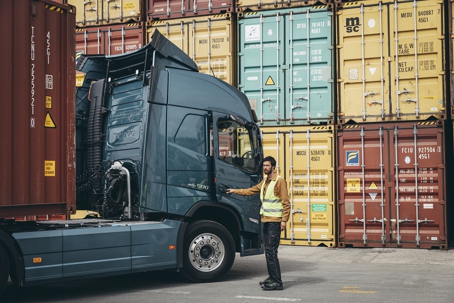 man opening the door of a volvo truck