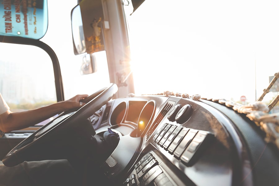 hand on a steering wheel of a truck