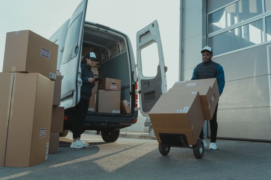 people loading goods in a van
